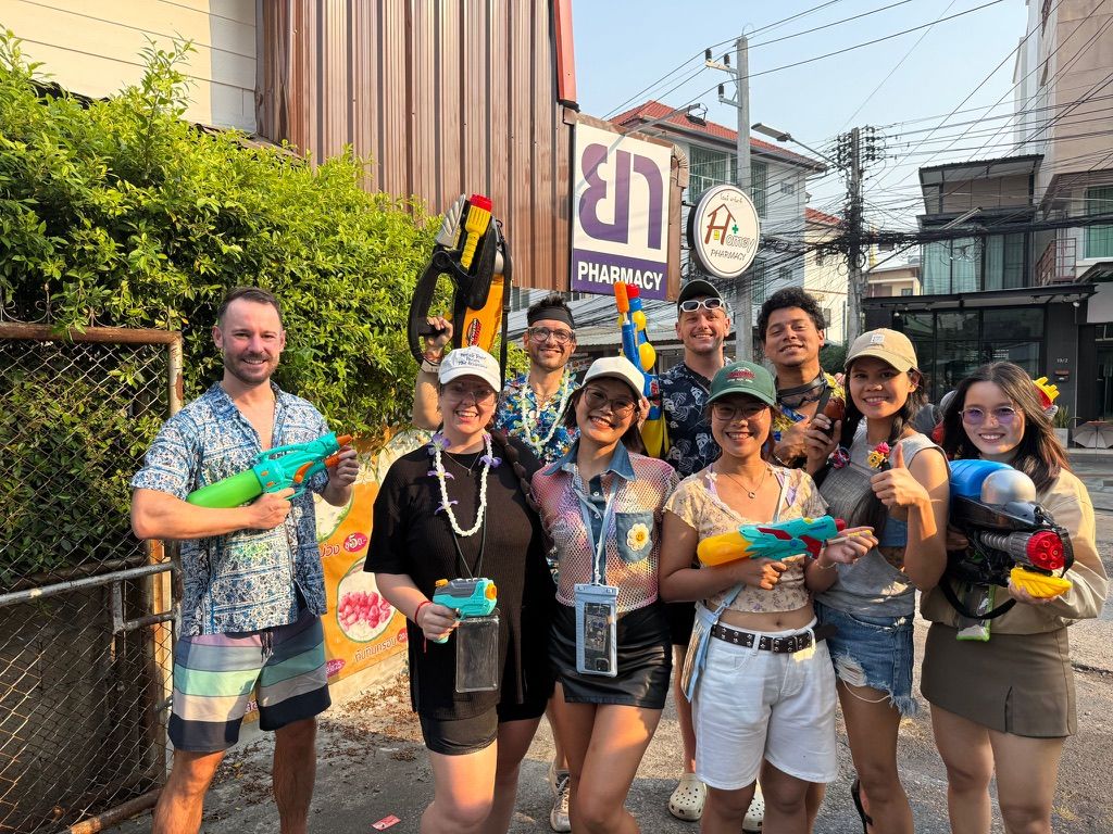 Dan with a group of friends holding water guns on a Chiang Mai street